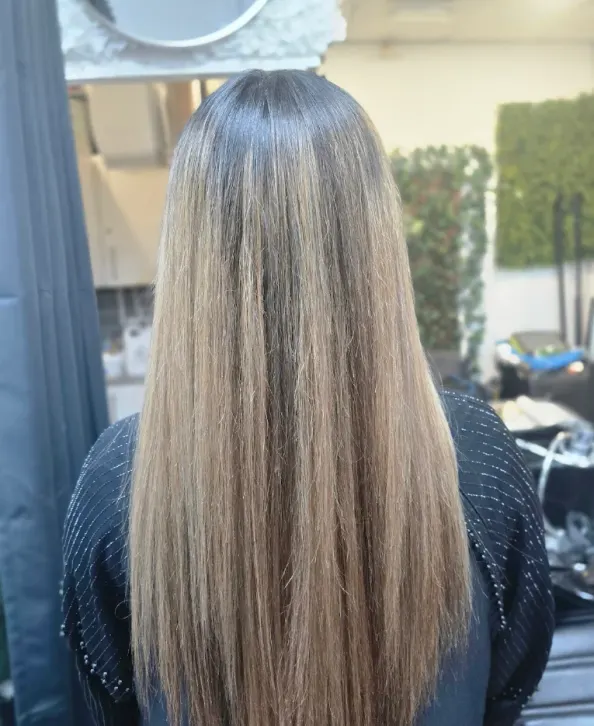 Long dimensional blonde hair result created at Naz Hair and Beauty